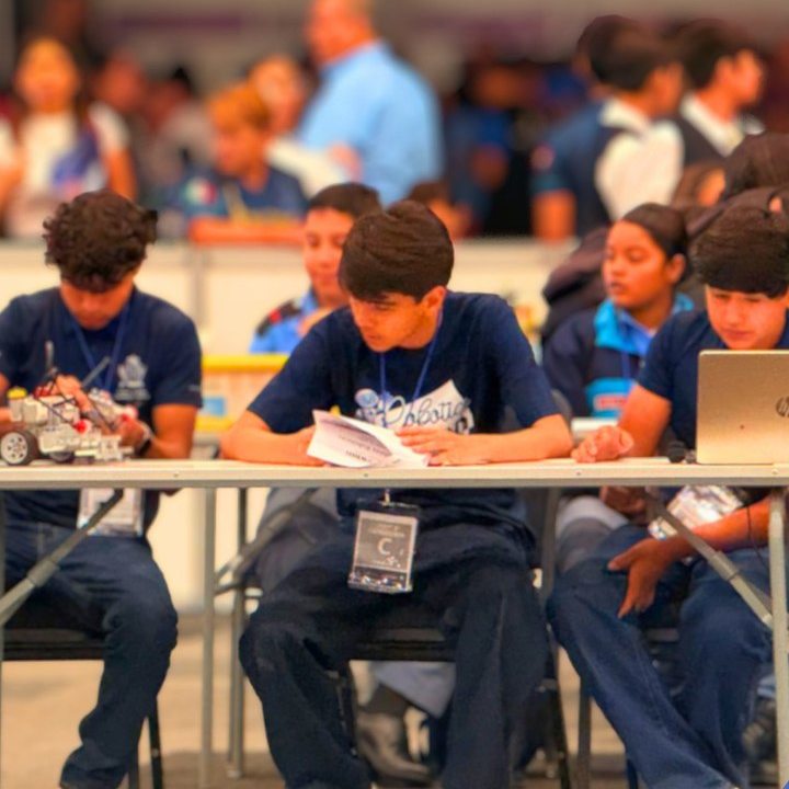 Alumnos con sus robots en la competencia de robótica del AMCO Summit